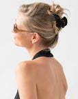 Woman with straight, blonde hair styled in an updo with a France Luxe medium claw hair clip, marbled pearlescent black.