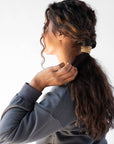 Thick hair ties with style. Woman using L. Erickson ponytail holders in her low ponytail.