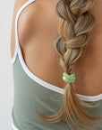 L. Erickson Green, no damage hair ties, styling light brown, straight, braided ponytail.