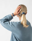 L. Erickson Blue, no damage hair ties, styling blonde, straight, low ponytail.
