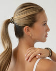 Thick hair ties with style. Woman using L. Erickson ponytail holders in her ponytail.