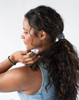 Thick hair ties with style. Woman using L. Erickson ponytail holders in her low ponytail.
