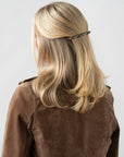France Luxe long French barrette for women pictured holding straight, blonde hair in a half up hairstyle.