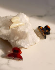 Several elegant Mini Couture French Hair Clips by France Luxe pictured on crystal.