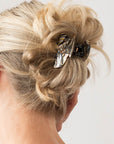 Woman with straight, blonde hair styled in a twist updo with a France Luxe small, Grey claw hair clip.