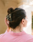 Woman with straight, brown hair styled in a twist updo with a France Luxe medium, Ivory Tortoiseshell claw hair clip.