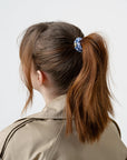 L. Erickson hair ties used to style brown, straight hair in sleek ponytail, Blue & Gold bands.