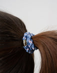 Woman with brown, straight hair styled in a sleek ponytail using Blue & Gold, thick hair ties.