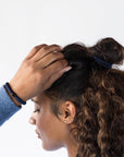 L. Erickson thick hair ties, styling dark brown, voluminous, curly , loose, half up do. Blue hair bands