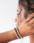 Brown hair ties for thick hair, seen on wrist. Cute ponytail holders by L. Erickson.