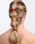 L. Erickson thick hair ties, styling blonde, straight, bubble ponytail. Orange hair bands