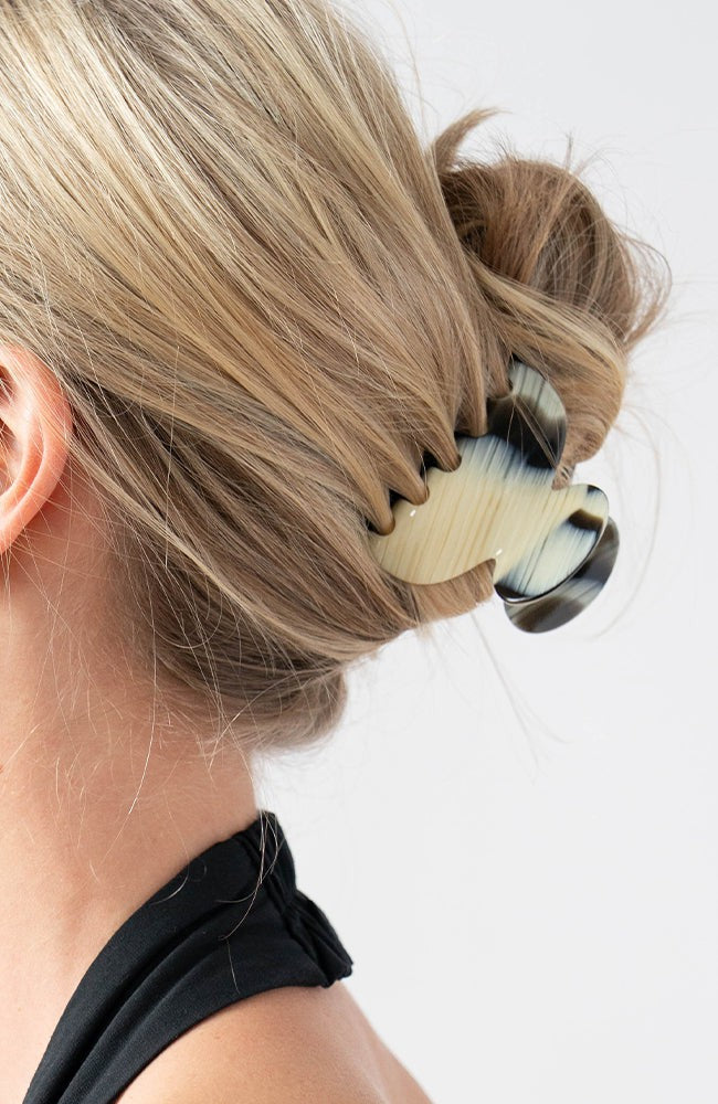 Woman with straight, blonde hair styled in a twist updo with a France Luxe small, Black &amp; White claw hair clip.