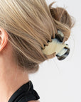 Woman with straight, blonde hair styled in a twist updo with a France Luxe small, Black & White claw hair clip.