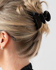 Woman with straight, blonde hair styled in a twist updo with a France Luxe small, Black claw hair clip.