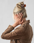 Woman with straight, blonde hair styled in a twist updo with a France Luxe small, Tortoiseshell claw hair clip.