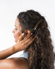 Womens metallic brown, French Barrette, ideal for most hair types, seen styling side-swept, brown, curly hair.