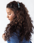 Womens light blue, French Barrette, ideal for most hair types, seen styling side-swept, brown, curly hair.