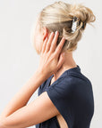 Woman with straight, blonde hair styled in an updo with a France Luxe medium claw hair clip, Tortoise Shell.
