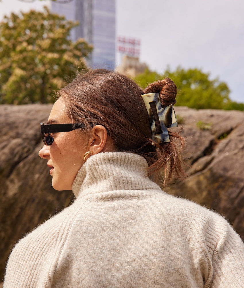 Outdoor fall outfit with large hair clip holding a twist at the back of the head. 