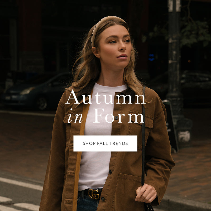 Woman in a brown jacket standing on a street with 'Autumn in Form' text overlay.