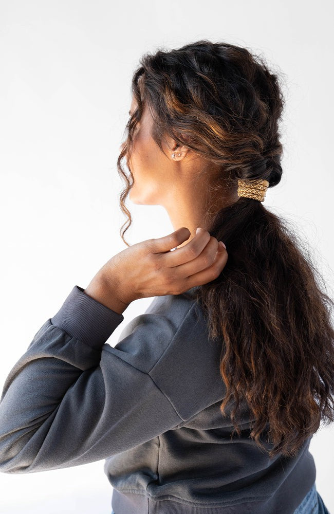 Thick hair ties with style. Woman using L. Erickson ponytail holders in her low ponytail.