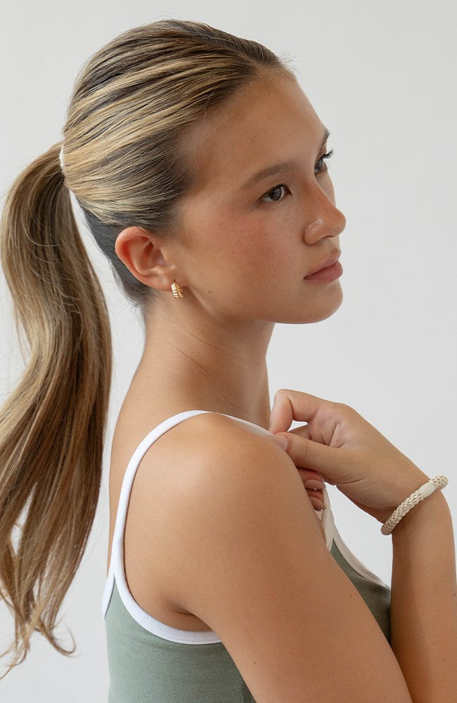 Woman using neutral L. Erickson hair ties for fine hair. Strong and gentle. Damage free, crease free.