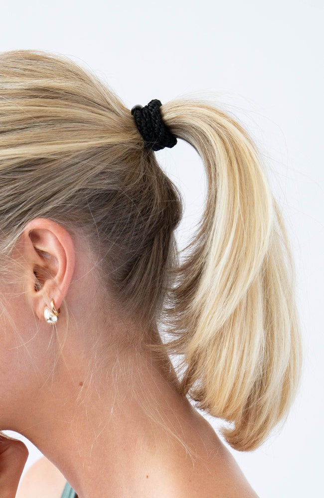 Black hair ties styling a straight ponytail. L. Erickson Grab &amp; Go Pony, Blush.