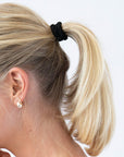 Black hair ties styling a straight ponytail. L. Erickson Grab & Go Pony, Blush.