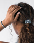 Thick hair ties with style. Woman using L. Erickson ponytail holders in her low ponytail.