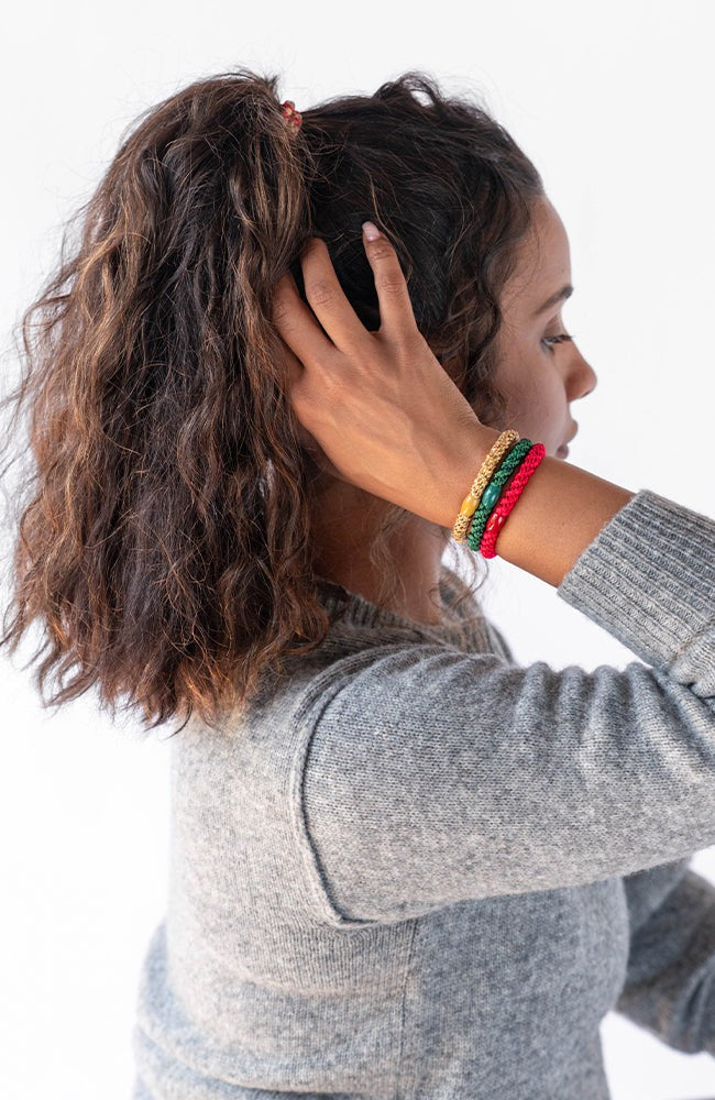L. Erickson holiday themed, no damage hair ties, styling dark brown, voluminous, curly, high ponytail with festive hair tie bracelets.