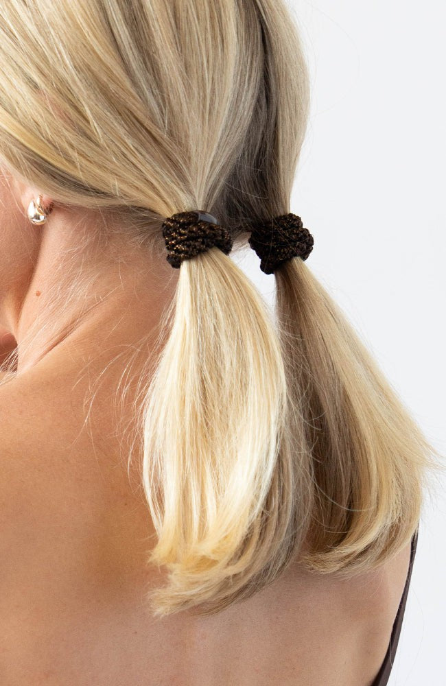 Thick hair ties with style. Woman using L. Erickson ponytail holders in her pigtails.