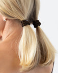 Thick hair ties with style. Woman using L. Erickson ponytail holders in her pigtails.