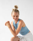 Thick hair ties with style. Woman using L. Erickson ponytail holders in her loose, high bun.