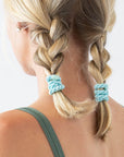 Thick hair ties with style. Woman using L. Erickson ponytail holders in her braided pigtails.