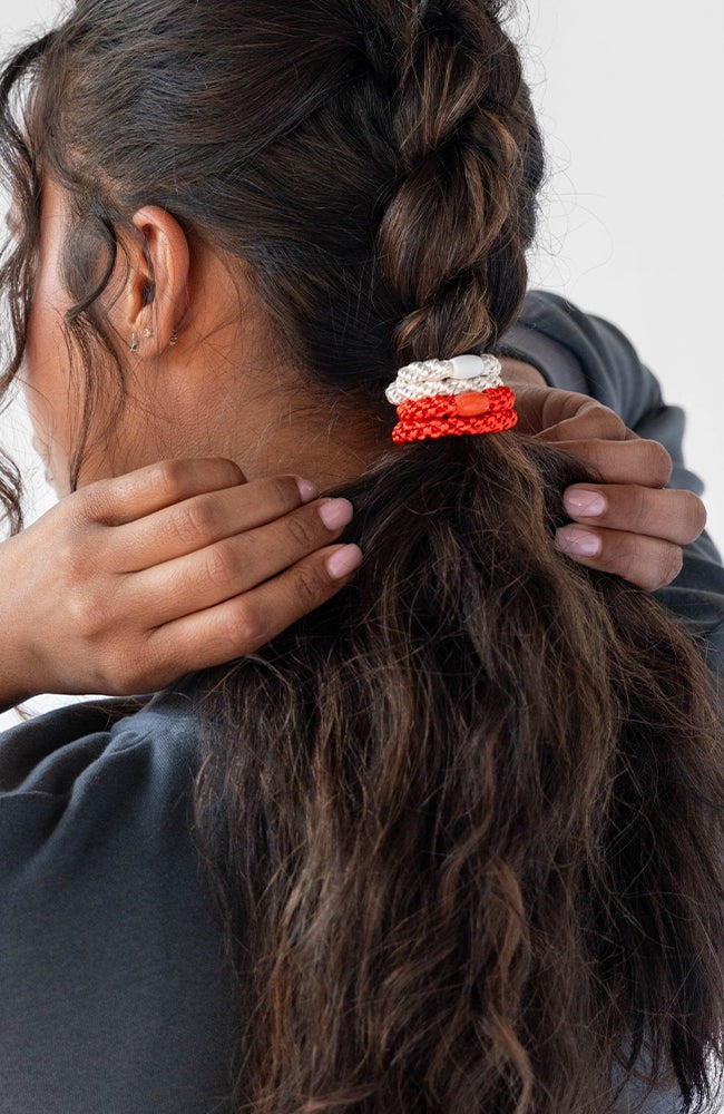 L. Erickson Orange &amp; White, no damage hair ties, styling dark brown, curly, dutch braid ponytail.