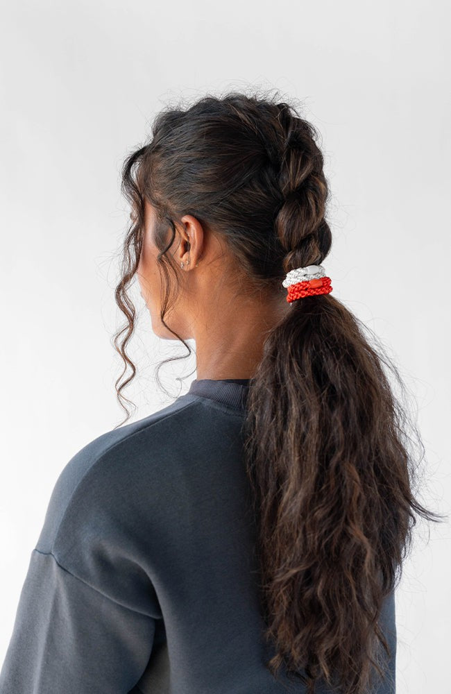 L. Erickson thick hair ties, styling dark brown, curly, dutch braid ponytail. Orange &amp; White hair bands