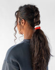 L. Erickson thick hair ties, styling dark brown, curly, dutch braid ponytail. Orange & White hair bands
