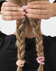 L. Erickson thick hair ties, styling light brown, straight, double braided ponytail. Pink hair bands