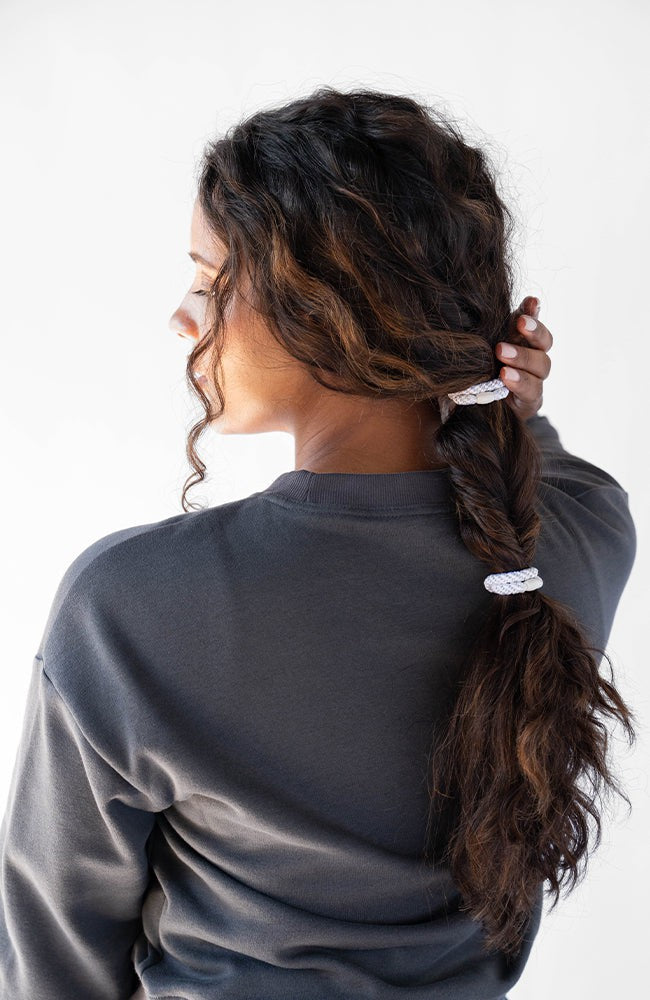 Black hair ties styling a thick, bubble ponytail. L. Erickson Grab &amp; Go Pony, Black Opal.
