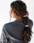 Black hair ties styling a thick, bubble ponytail. L. Erickson Grab & Go Pony, Black Opal.