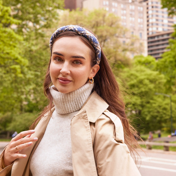 Fall outfit with a blue padded headband and light brown trench coat with a turtleneck sweater. L. Erickson hair accessories for fall.