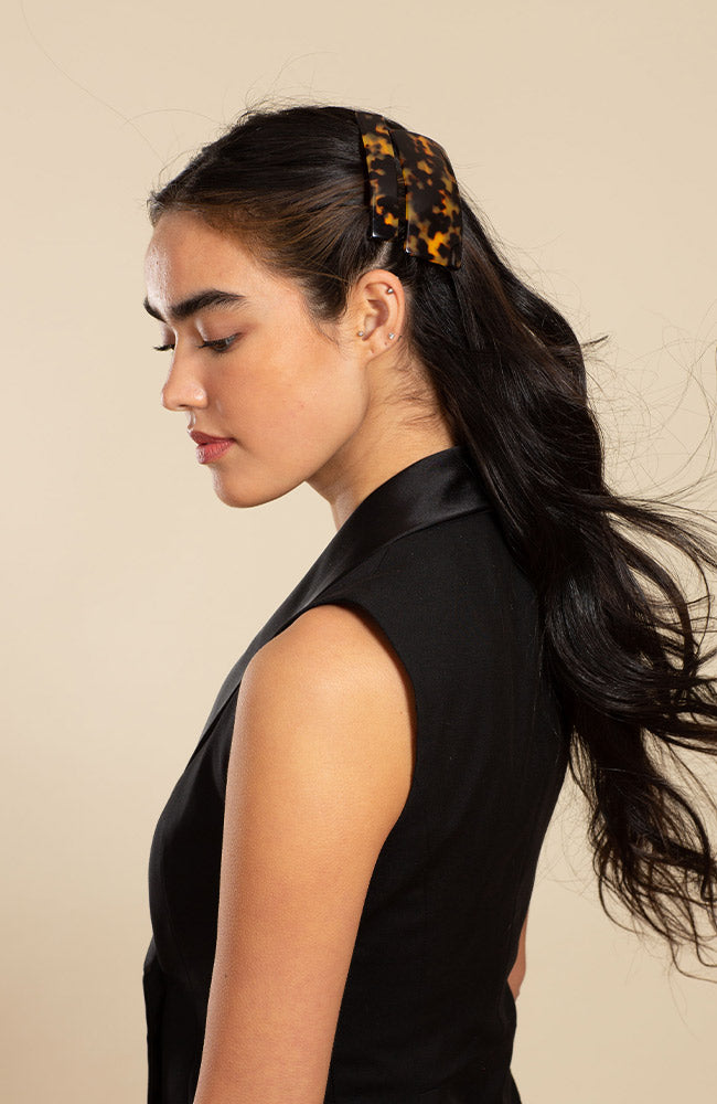 Womens classic tortoiseshell, French Barrette, ideal for most hair types, seen styling side-swept, black, straight hair.