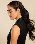 Womens classic tortoiseshell, French Barrette, ideal for most hair types, seen styling side-swept, black, straight hair.
