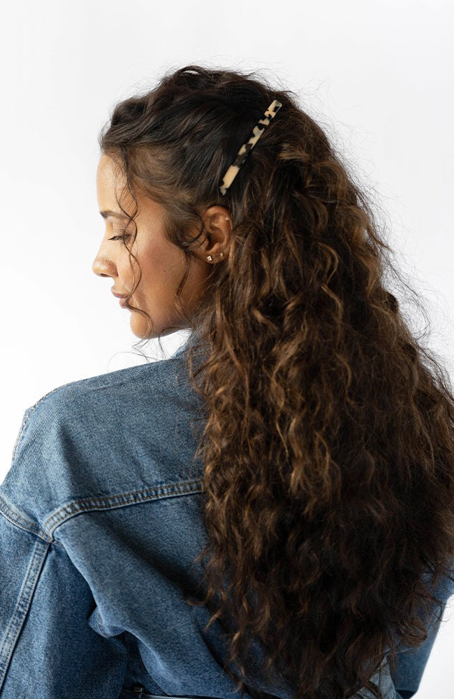 Womens Ivory Tortoiseshell French Barrette styling side-swept, brown, curly hair. Hair accessory by France Luxe.
