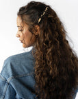 Womens Ivory Tortoiseshell French Barrette styling side-swept, brown, curly hair. Hair accessory by France Luxe.