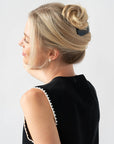 Woman with straight, blonde hair styled in a twist updo with a France Luxe large, Black barrette.