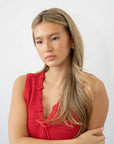 France Luxe thin headband in a marbled gray and charcoal color, pictured holding straight, blonde hair in a loose hairstyle.