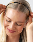 France Luxe Tortoise Shell headband for women pictured holding straight, blonde hair in a loose hairstyle.