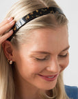 France Luxe Tortoise Shell headband for women pictured holding straight, blonde hair in a loose hairstyle.
