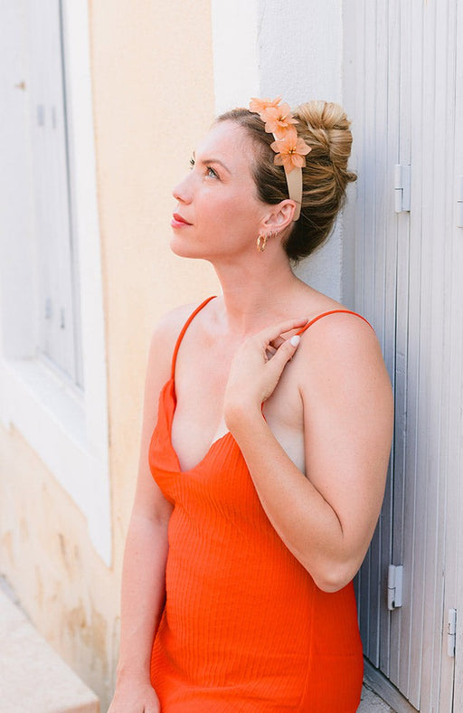 Orange flower headband styling blonde hair matched with an orange dress, Violetta Headband, Tan by L. Erickson